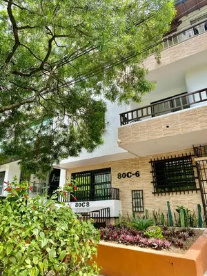 an apartment building with a balcony and plants at Loft - Laureles, interno con patio in Medellín