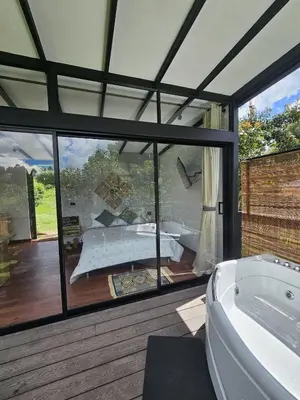 a large bathroom with a tub and a large window at Equilibrium glamping in Guarne