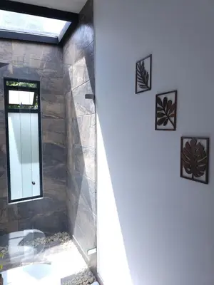 a bathroom with a shower with a mirror at Equilibrium glamping in Guarne