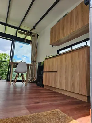 a living room with wooden cabinets and a table at Equilibrium glamping in Guarne
