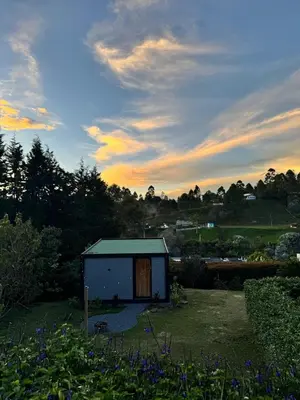 a small shed in the middle of a garden at Equilibrium glamping in Guarne