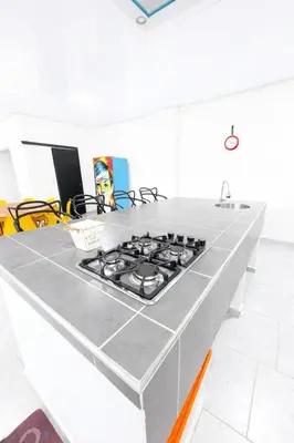 a kitchen counter with a stove top on it at KAWARA - Casa IWE in Mariquita