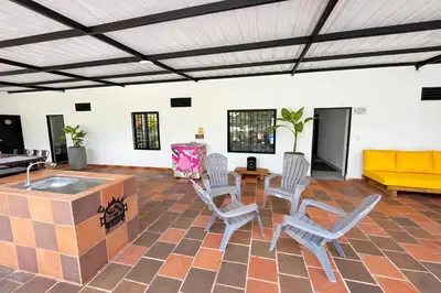 a living room with chairs and a yellow couch at KAWARA - Casa IWE in Mariquita