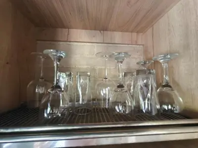 a bunch of wine glasses sitting on a shelf at Casa Entre Montañas in Titiribí