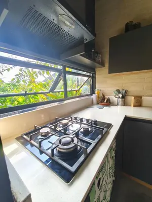 a stove top oven in a kitchen with a window at Casa Entre Montañas in Titiribí
