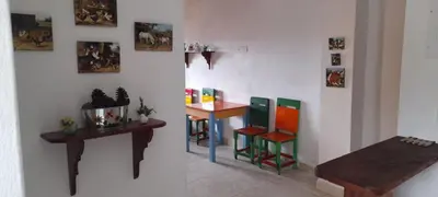 a room with colorful chairs and a table at Hostal LaMula in Jardin