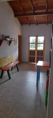 a room with two benches and a table and a door at Hostal LaMula in Jardin