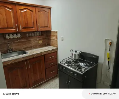 a kitchen with a black stove and a sink at Apartamento en el centro de Riosucio in Ruiosucio