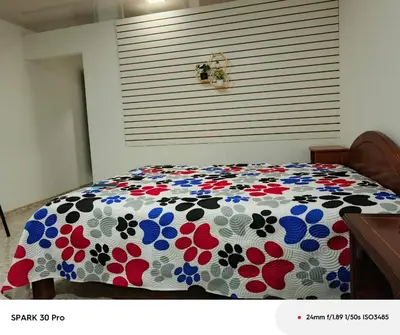a bedroom with a bed with a floral comforter at Apartamento en el centro de Riosucio in Ruiosucio