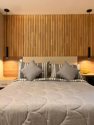 a bedroom with a large bed with two pillows at Modern Loft Puerta de Laureles Medellin in Medellín