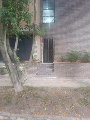 a building with a door and stairs in front of it at Modern Loft Puerta de Laureles Medellin in Medellín