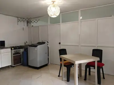 a kitchen with a table and chairs in a room at Apartaestudio Centro Histórico Medellín in Medellín