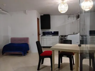 a kitchen with a table and chairs in a room at Apartaestudio Centro Histórico Medellín in Medellín