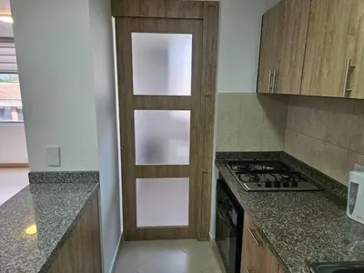 a kitchen with a door in the middle of it at Loft urbano cerca a cable plaza in Manizales