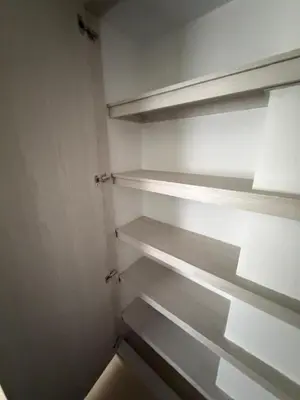 a walk in closet with empty shelves in it at Moderno y acogedor apartamento en sabaneta in Sabaneta
