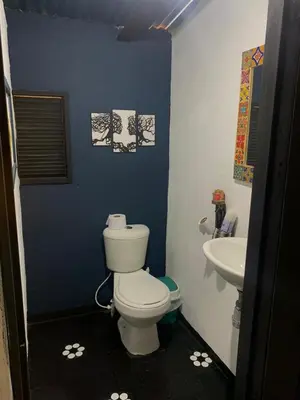 a bathroom with a toilet and a sink at El Edén in Guarne