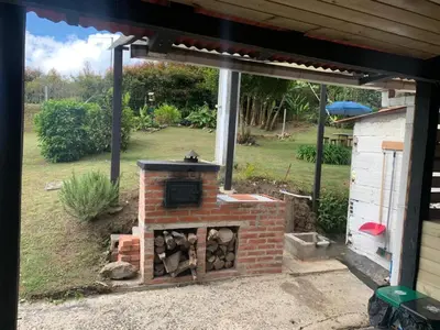 an outdoor brick oven in the backyard of a house at El Edén in Guarne