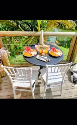 a table with plates of food on a porch at Konkor Aldea in Chiquinquirá
