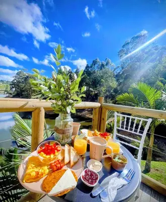 a tray of breakfast food on a table on a balcony at Konkor Aldea in Chiquinquirá