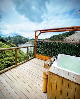 a bath tub on a deck with a view of a river at Konkor Aldea in Chiquinquirá