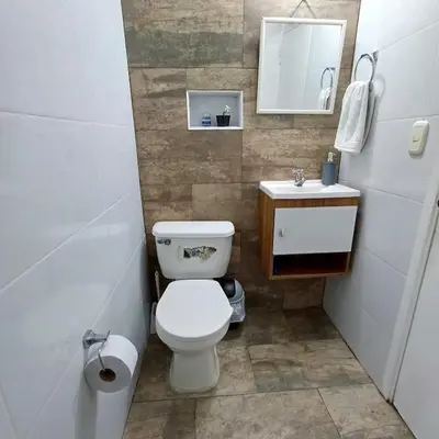a small bathroom with a toilet and a sink at Acogedor Y Amplio Aparta estudio En El Corazón De Manizales in Manizales