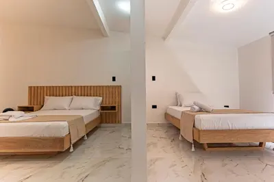 two beds sitting next to each other in a room at Hotel Loft 72 in Medellín