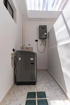 a small room with a refrigerator and a window at Hotel Loft 72 in Medellín