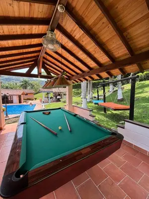 a pool table on a patio with awning at Villa en Salgar - Bolombolo in Montenegro