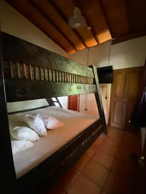 a bunk bed with two pillows in a room at Villa en Salgar - Bolombolo in Montenegro