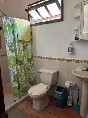a bathroom with a toilet and a sink and a window at Villa en Salgar - Bolombolo in Montenegro