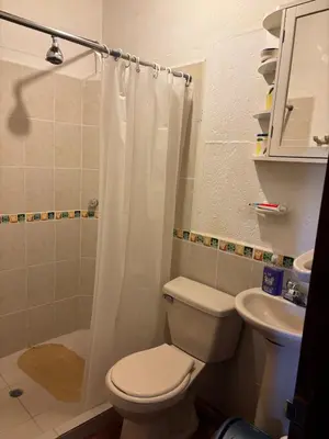 a bathroom with a toilet and a shower and a sink at Villa en Salgar - Bolombolo in Montenegro