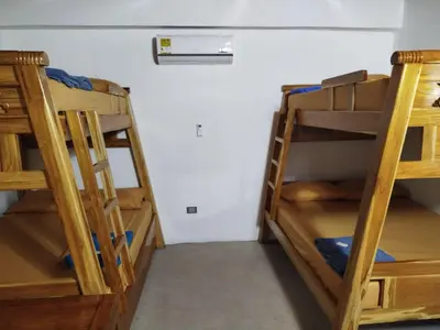 two bunk beds in a room with a wall at Buenos Aires in Doradal