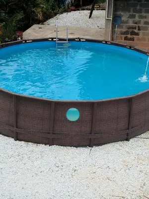 a large swimming pool with a wooden fence around it at Buenos Aires in Doradal