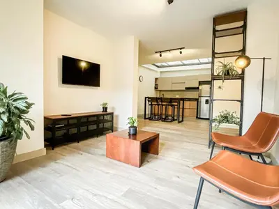 an open living room with a table and chairs at Vive Medellin apartamento in Envigado