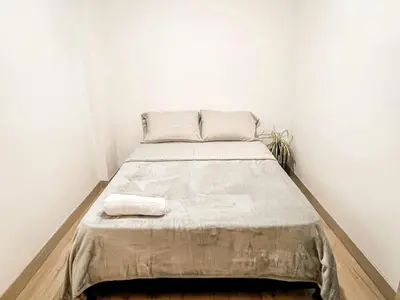 a bed in a room with white walls at Vive Medellin apartamento in Envigado