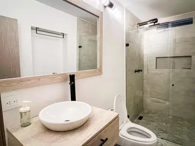 a bathroom with a sink and a toilet and a shower at Vive Medellin apartamento in Envigado