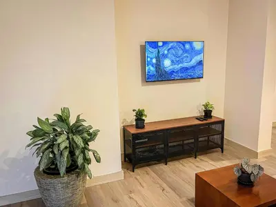 a living room with a table and a potted plant at Vive Medellin apartamento in Envigado
