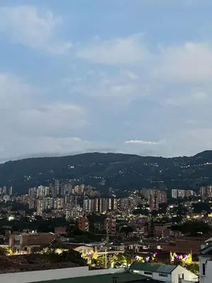 a view of a city with buildings and mountains at Vive Medellin apartamento in Envigado