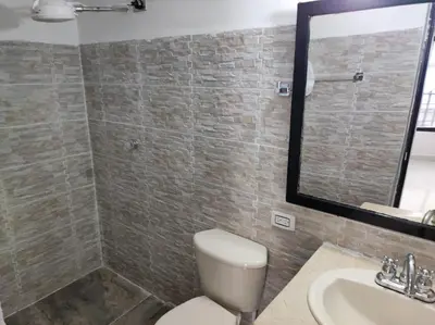 a bathroom with a toilet and a sink and a mirror at Finca Villa Lake in Horizonte