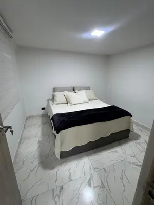 a bed in a white room with a marble floor at Apartment in Itagui, excellent location in Itagüí