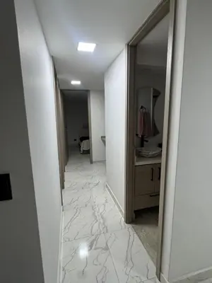 a hallway with a bathroom with a sink and a mirror at Apartment in Itagui, excellent location in Itagüí