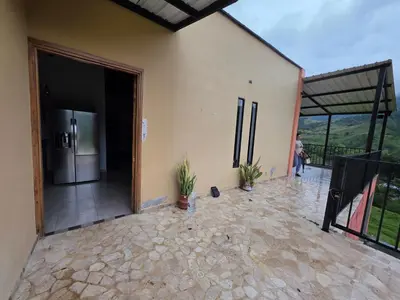 an open door of a house with a refrigerator at FINCA DE RECREO y DESCANSO in El Bosque