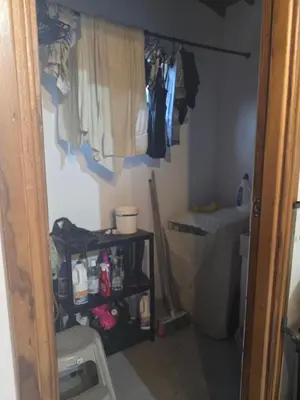 a room with a closet with clothes hanging on the wall at FINCA DE RECREO y DESCANSO in El Bosque