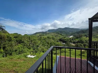 a balcony with a view of the mountains at FINCA DE RECREO y DESCANSO in El Bosque