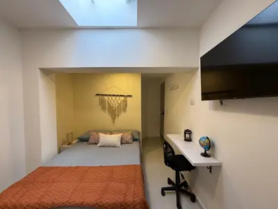 a small bedroom with a bed and a desk at Sencia Apartamentos Boutique in Medellín