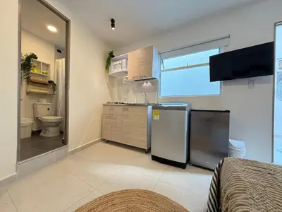 a kitchen with a sink and a toilet in a room at Sencia Apartamentos Boutique in Medellín