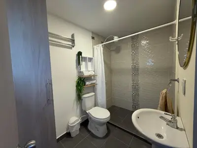 a bathroom with a toilet and a sink and a shower at Sencia Apartamentos Boutique in Medellín