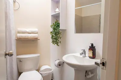 a white bathroom with a toilet and a sink at Sencia Apartamentos Boutique in Medellín