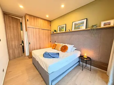 a bedroom with a bed and a table with a lamp at Montecielo Lodge 11 El peñol - Guatape in Chiquinquirá
