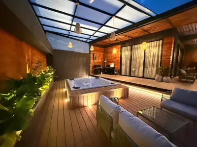 a living room with a hot tub on a wooden deck at Montecielo Lodge 11 El peñol - Guatape in Chiquinquirá